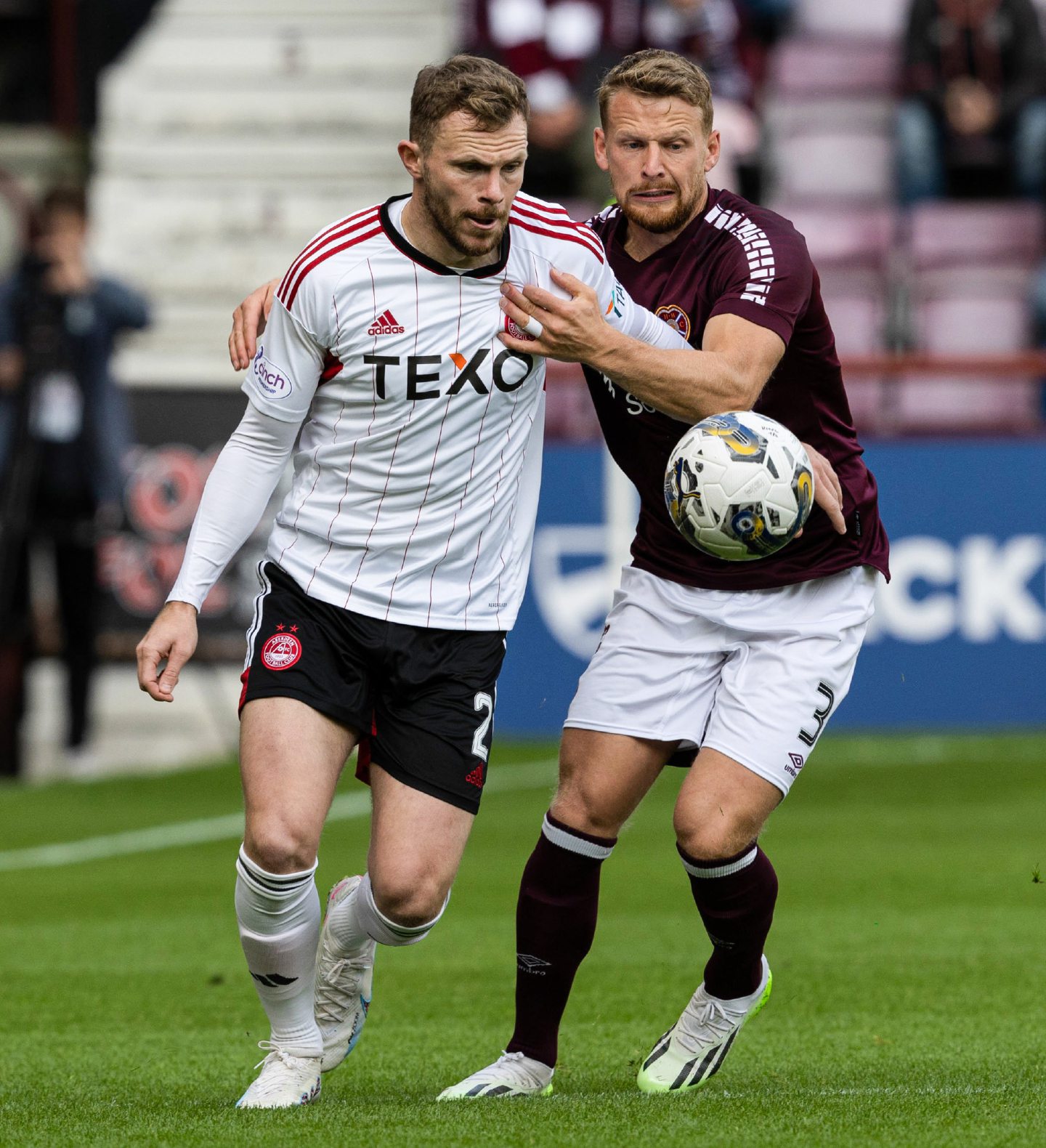 Aberdeen's Nicky Devlin and Hearts' Stephen Kingsley in action