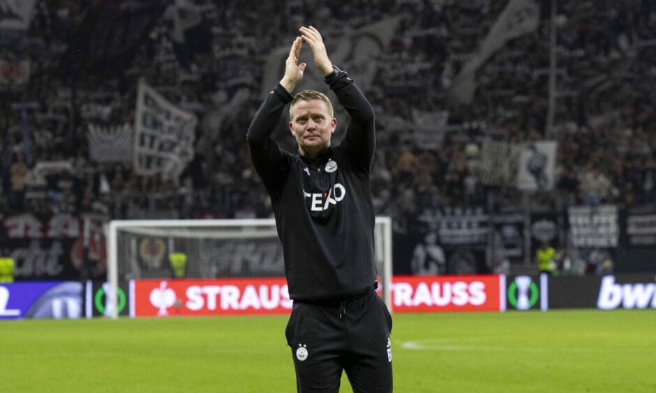Aberdeen manager Barry Robson clapping his hands after the Eintracht Frankfurt game.