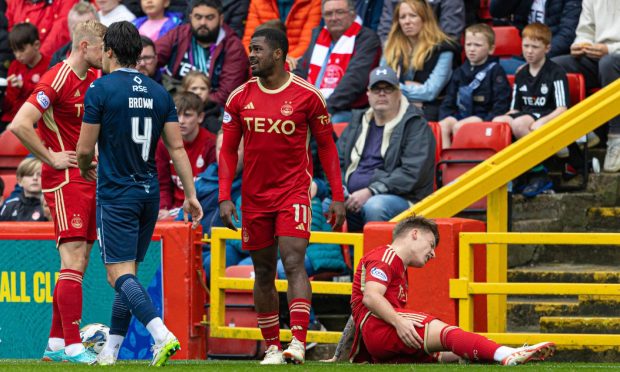 Aberdeen's James McGarry suffers an injury early on against Ross County. Image: SNS.