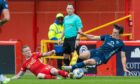 Ross County's James Brown (R) fouls Aberdeen's Jonny Hayes - and is yellow carded. Image: SNS