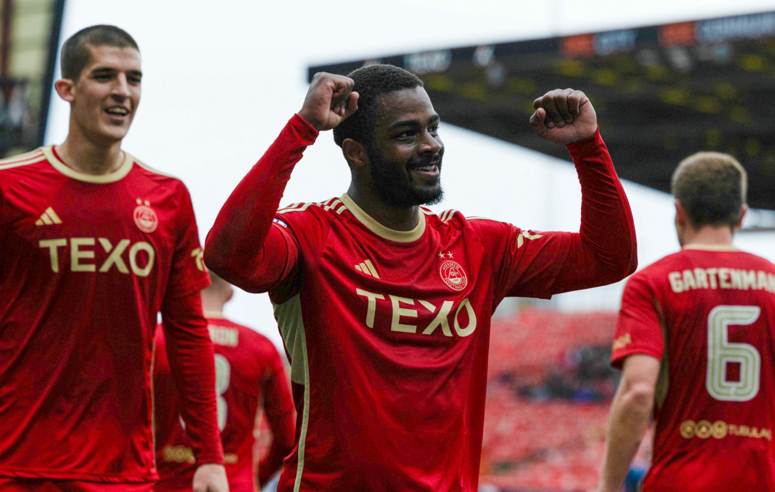 Dons' Duk celebrates scoring to make it 2-0 against Staggies. 