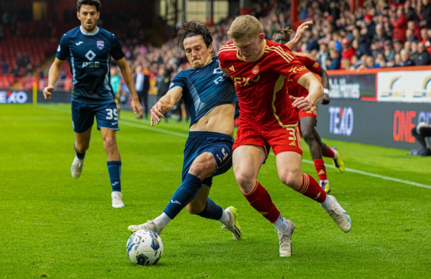 Ross County's James Brown and Aberdeen's Jack MacKenzie in action at Pittodrie.