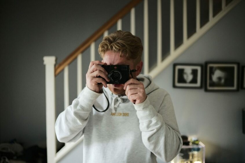 Michael Carver taking a photo of himself in mirror.