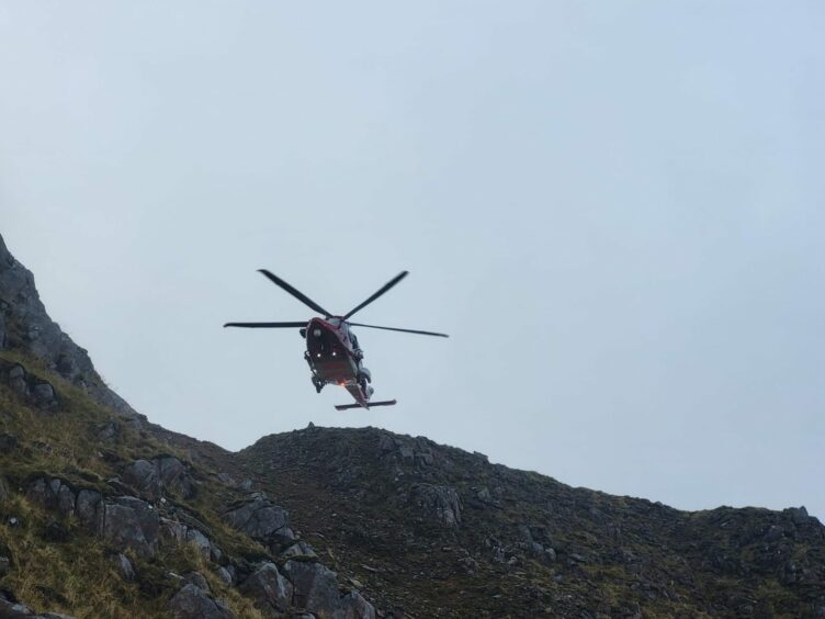 A rescue helicopter surveyed the area from above.