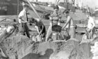 This may look like a beach seen, but it's actually Robert Gordon's College schoolboys filling sandbags in the harbour area on September 4 just after war was declared. The North of Scotland Orkney and Shetland Steamship Co steamship St Sunniva is in the background. Image: DC Thomson