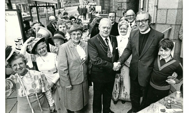 1985: Lord Provost Henry Rae, centre, is welcomed to the new centre on its opening day by the Rev. David Graham, centre right, of Rutherford Church. Image: DC Thomson