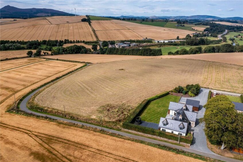 Aerial view of the 7.5 acre field behind the Aberdeenshire farmhouse, along with sweeping views over the Inverurie countryside.
