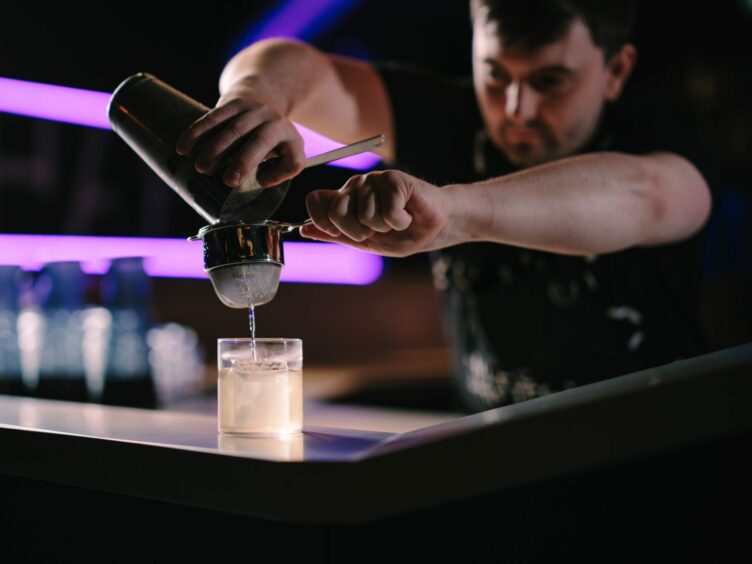 ShapeShifters bartender preparing a signature cocktail.