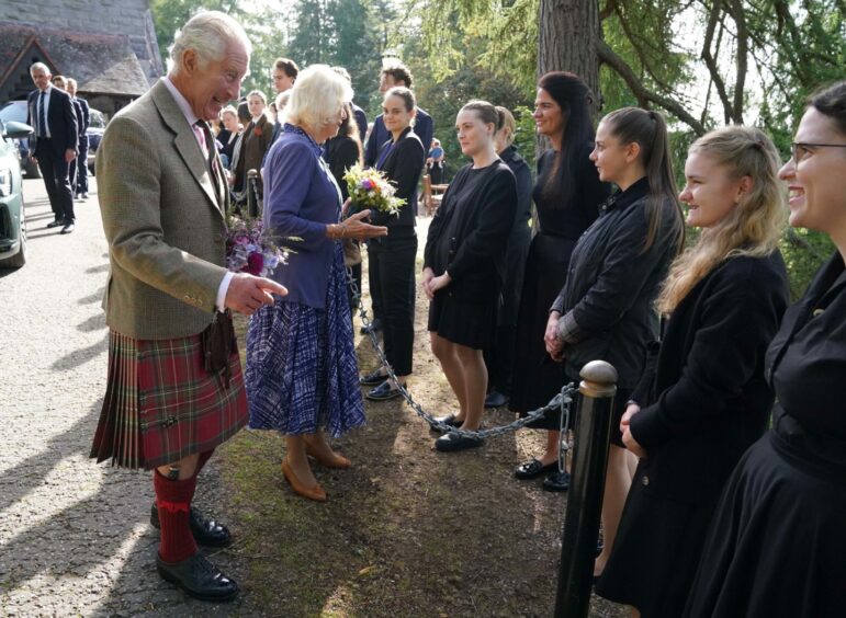 Charles and Camilla outside Crathie Kirk talking to the public 