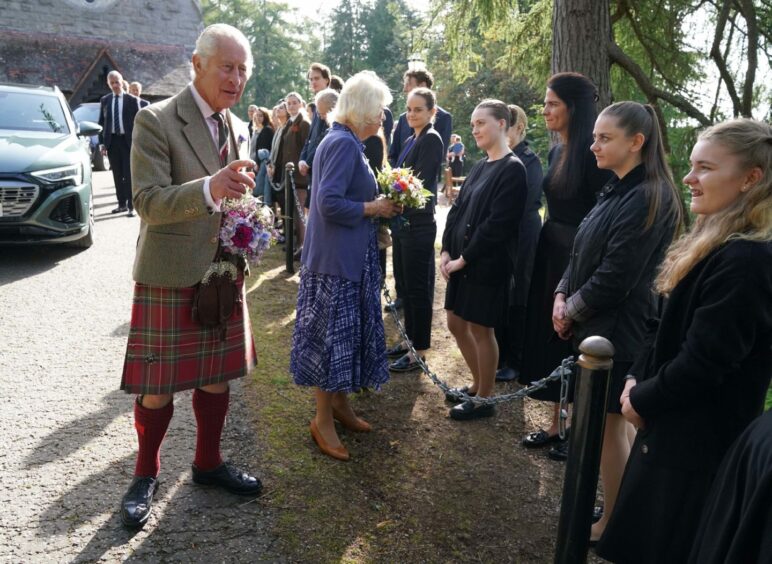 King Charles III and Queen Camilla meet estate staff and members of the public as they leave Crathie Parish Church, near Balmoral, after a church service, to mark the first anniversary of the death of Queen Elizabeth II