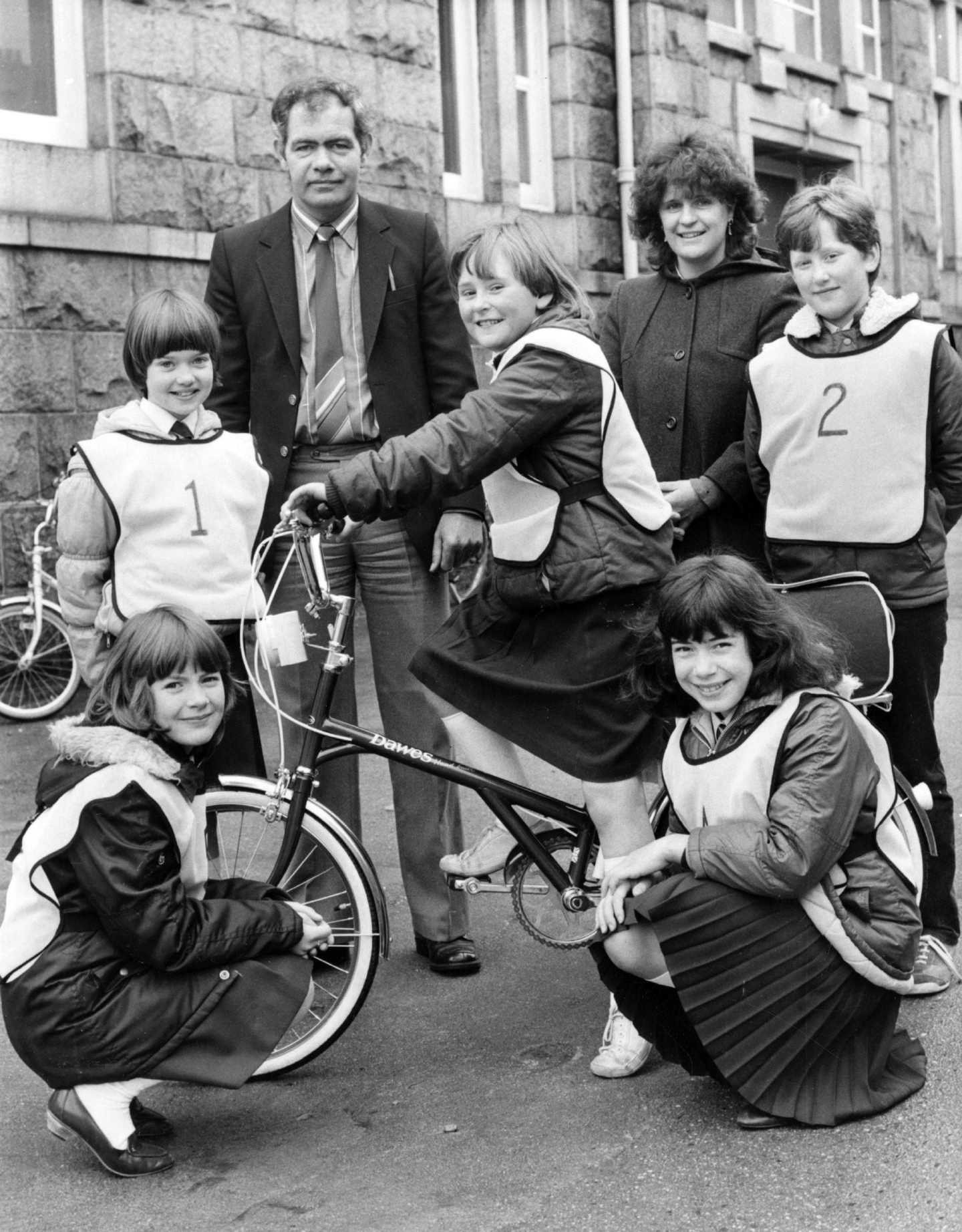 Pupil Debbie Noble on a bicycle in preparation for a road safety competition with school friends Carole Reid, Brenda King, Alison Walker and Michelle Capes in 1983.