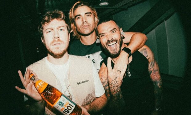 Busted holding a bottle of Irn Bru