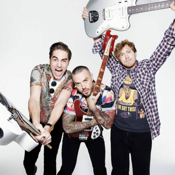 Busted band members holding electric guitars.