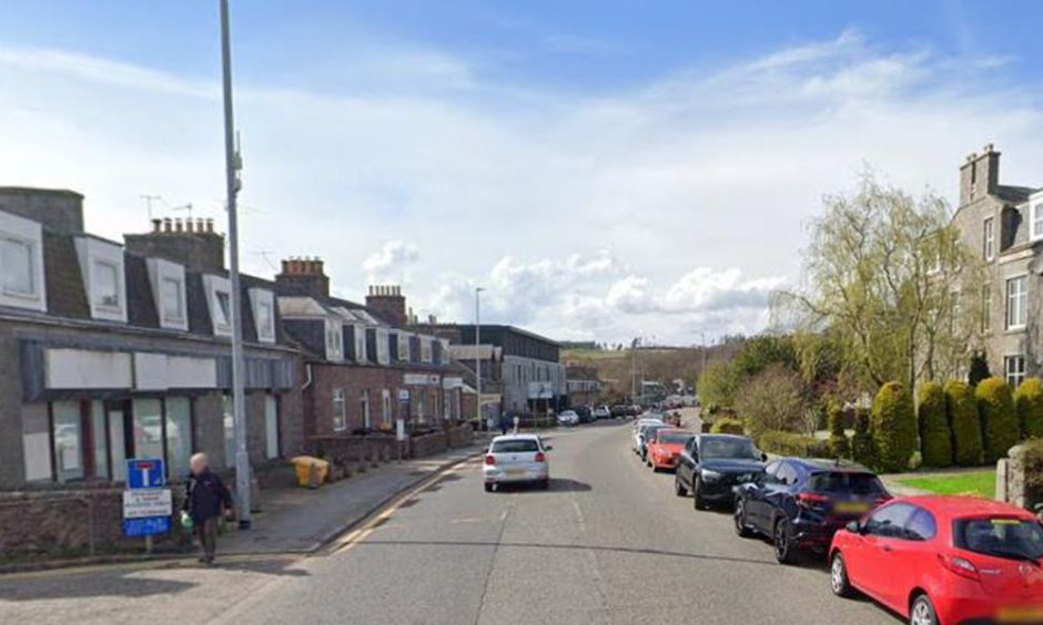 North Deeside Road, with buildings and cars.