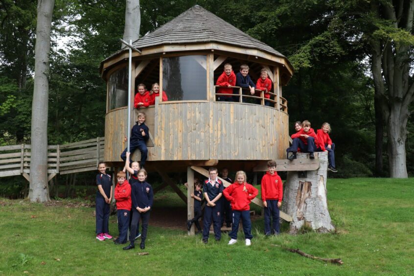 students pose in Lathallan's Treehouse Classroom