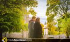a couple walks through the streets to see the autumn foliage, one of the fun things to do in Aberdeen