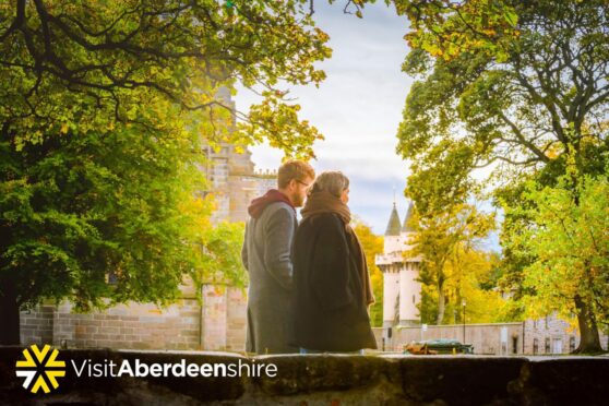 a couple walks through the streets to see the autumn foliage, one of the fun things to do in Aberdeen