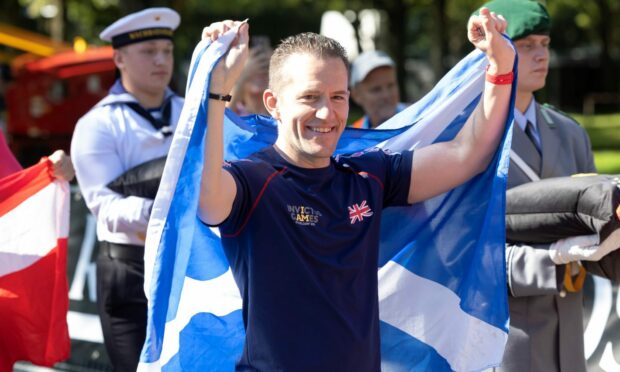 Aberchirder athlete David Jarvis with the Saltire following his 2023 Invictus Games gold medal success. Image: Royal British Legion.