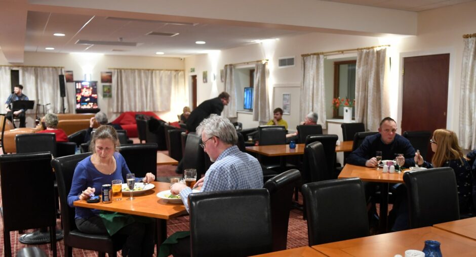 People sitting at tables at the Britannia Hotel in Aberdeen.