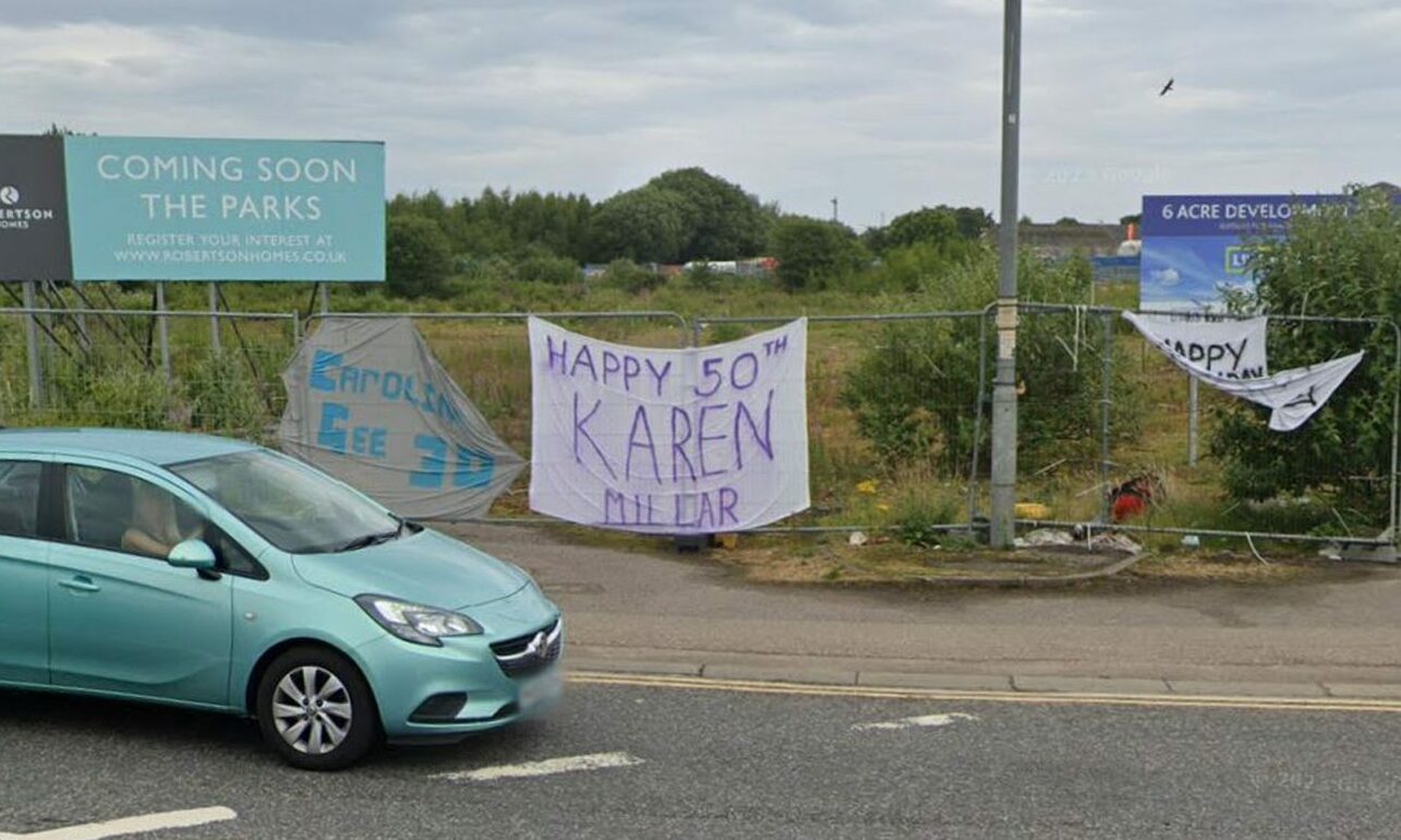 Google maps image of signs attached to fencing at Edgar Road roundabout. 