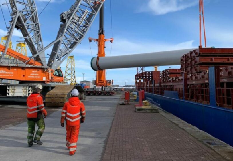 Turbine towers being transferred by crane at Port of Nigg. 