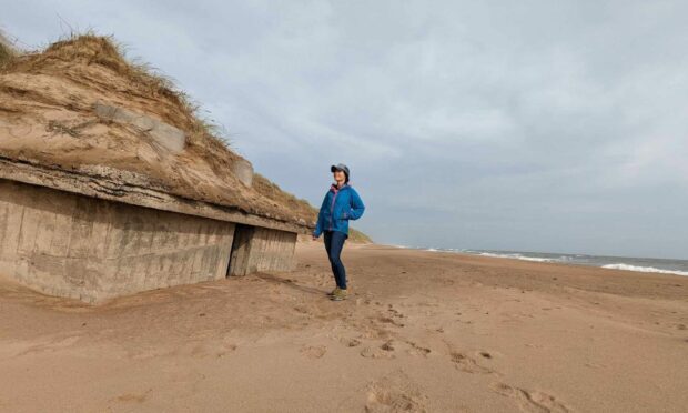 Gayle checks out the WWII pillbox that recently resurfaced on Blackdog Beach.
