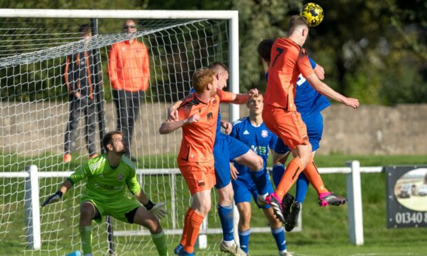 Ben Johnstone, number seven, heads in Rothes' goal against Lossiemouth. Pictures by Jasperimage
