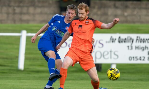 Greg Morrison of Rothes, right, and Brandon Hutcheson of Lossiemouth battle for the ball. Pictures by Jasperimage
