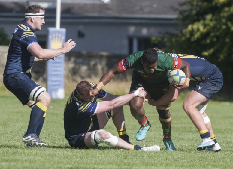 Timoci Junior on the ball for Highland against Dundee Rugby