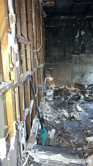 Debris fills the floor of the fire ravaged house.