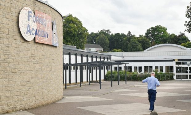 Wide shot of main entrance at Forres Academy with one person walking towards building.