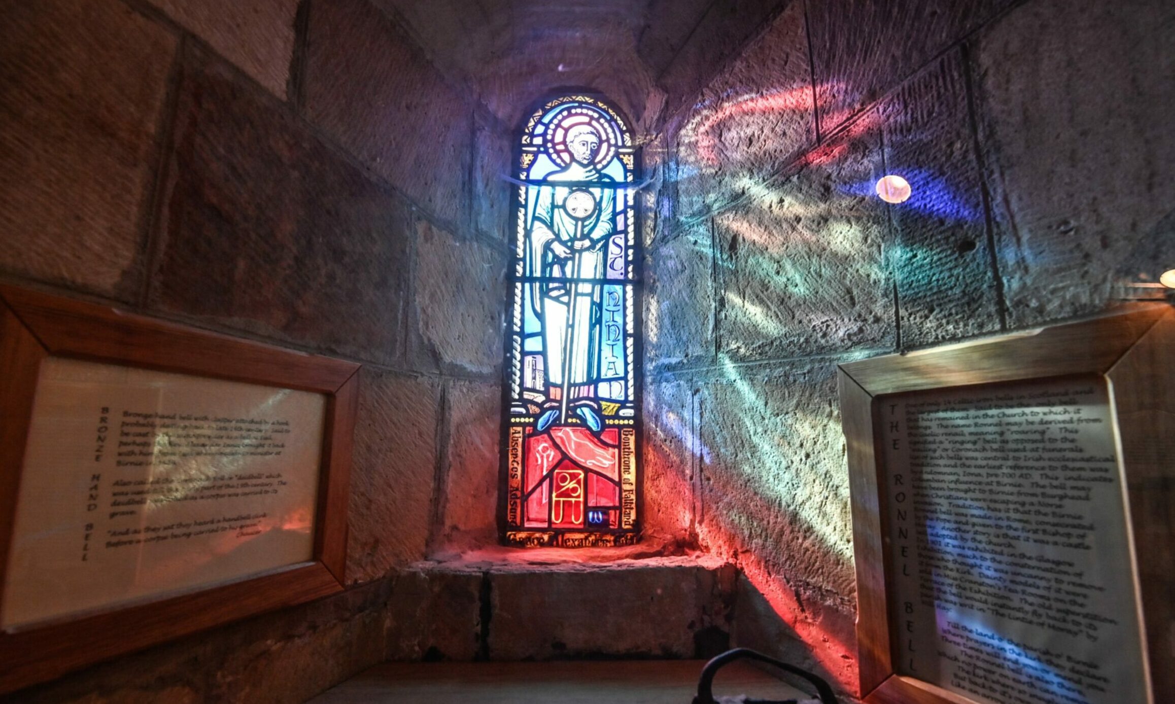 Colourful light bursting through stained glass window.