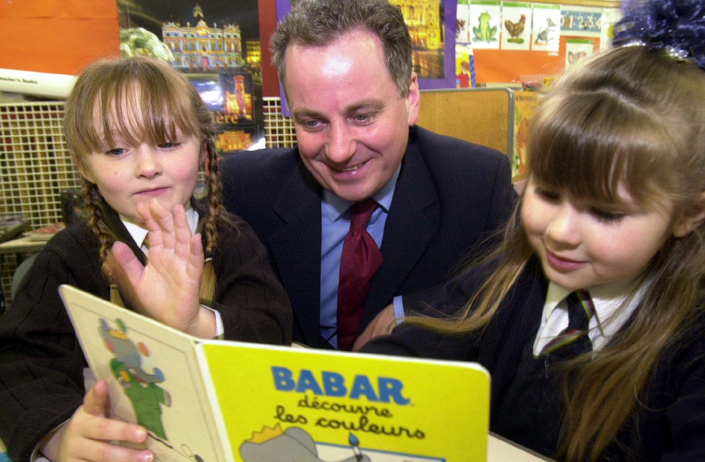 The then education minister Jack McConnell got to grips with reading French with the help of Walker Road School pupils Shanna Angus and Iona Monroe, both five, in Aberdeen.