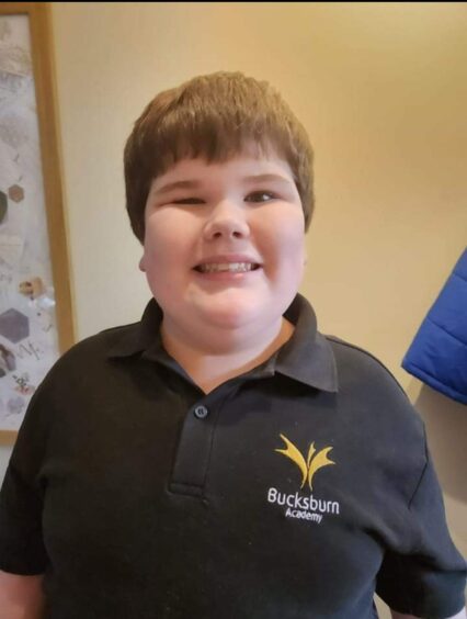 Johanna Petrie's disabled son Jack in his Bucksburn Academy polo shirt, smiling at the camera