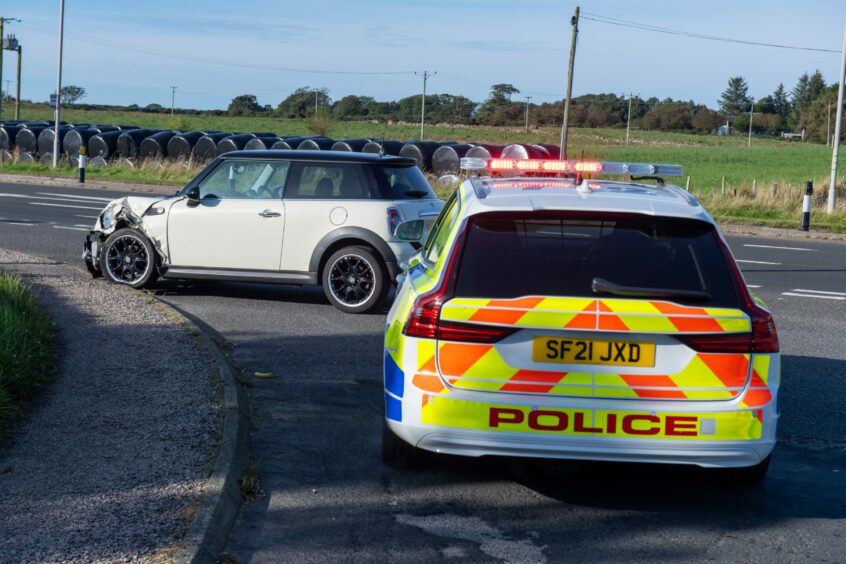 Police car and white Mini Cooper involved in crash near Portlethen 