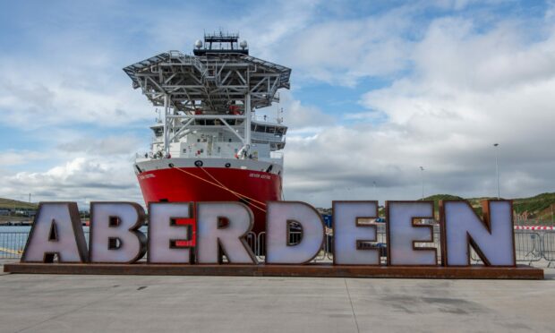 Ship and giant Aberdeen letters at Aberdeen South Harbour.