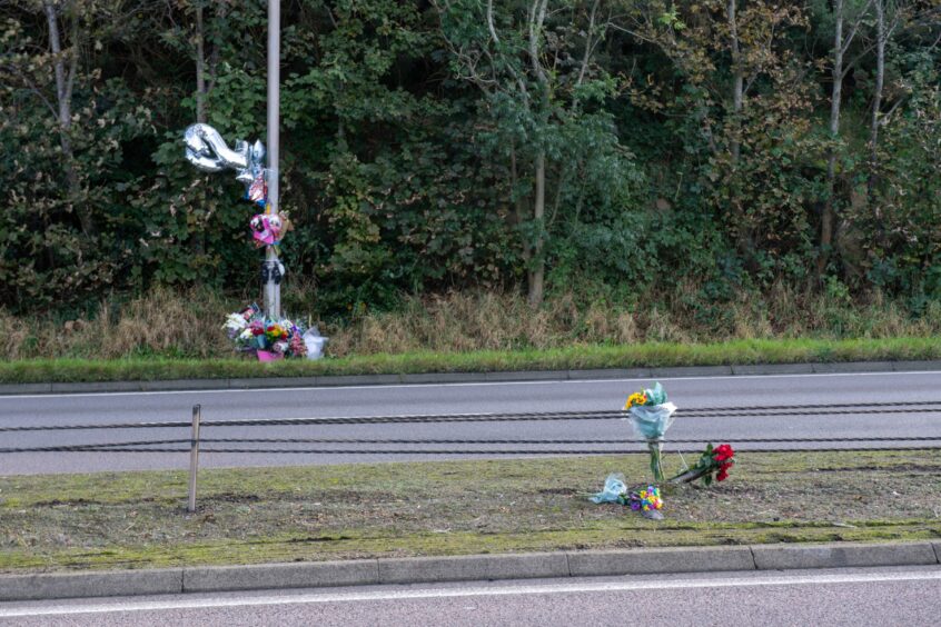 Tributes left at the side of the road.