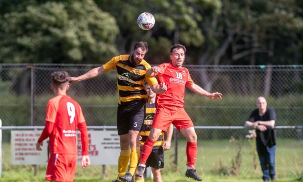 Stonehaven's Clark Robertson and Hermes' Callum Innes challenge for the ball. Image: Kath Flannery/DC Thomson