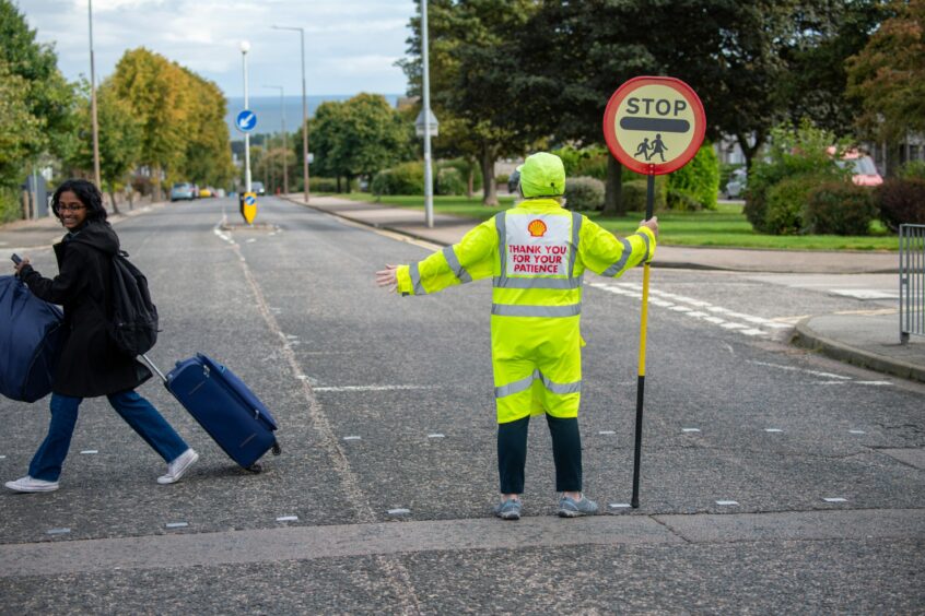 Aberdeen's lollipop school crossing patrollers are unlikely to be threatened by the Aberdeen budget for 2024-25. Image: Kami Thomson/DC Thomson