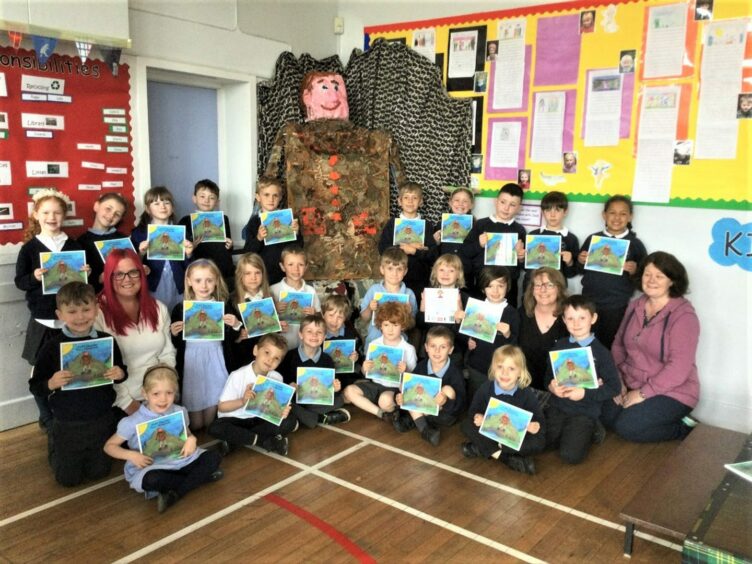 Monymusk School's P1-3 class with copies of their published book. Image: Aberdeenshire Council.