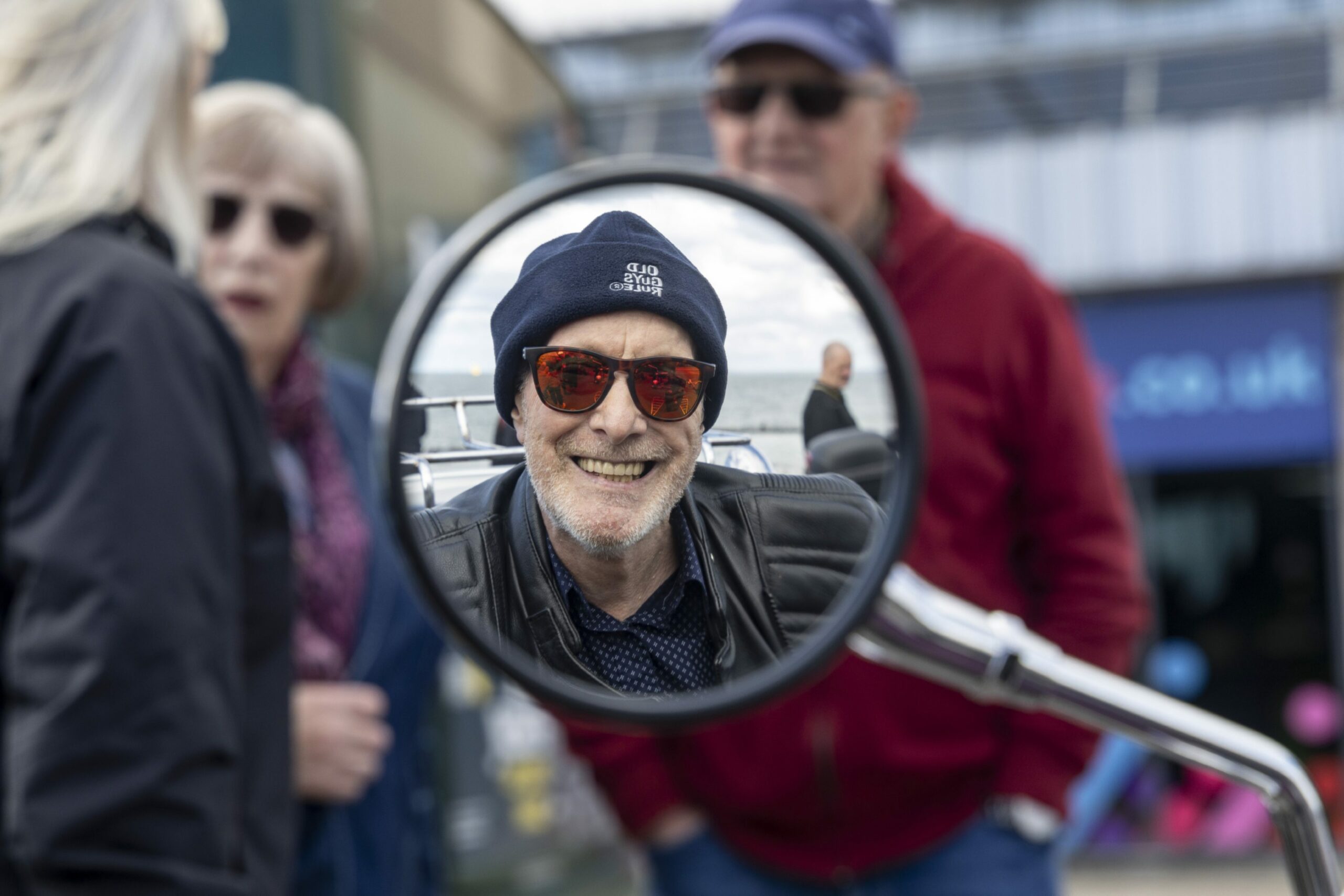 A smiling Edwin can be seen in the mirrors of his bike.