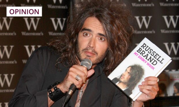 Russell Brand poses with a copy of his autobiography, My Booky Wook, in 2007 (Image: Jonathan Hordle/Shutterstock)
