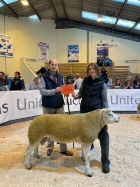 Nia Rainnie from Cobbleheugh, Dinnet, with her champion Texel shearling and judge Angus Greenlaw,