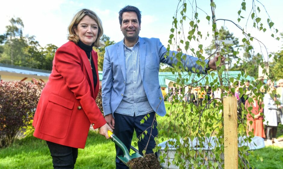 TV presenter and musician Fiona Kennedy plants a tree at Camphill School Aberdeen.