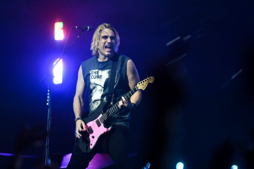 Charlie Simpson of Busted singing and playing guitar