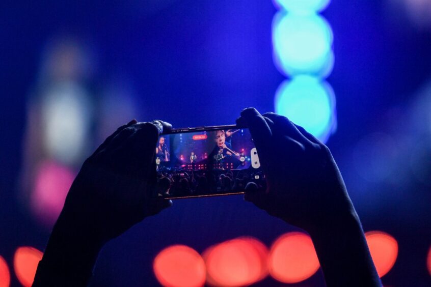 A fan pictured capturing the show