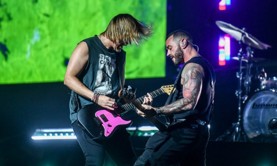 Charlie Simpson and Matt Willis playing guitar together