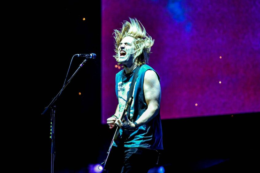 Charlie Simpson, headbanging playing guitar
