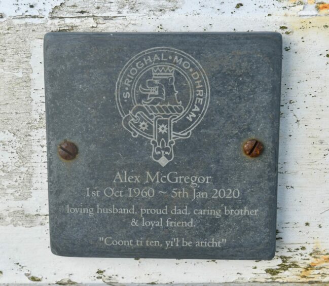 The memorial bench plaque dedicated to Alex McGregor of Torry