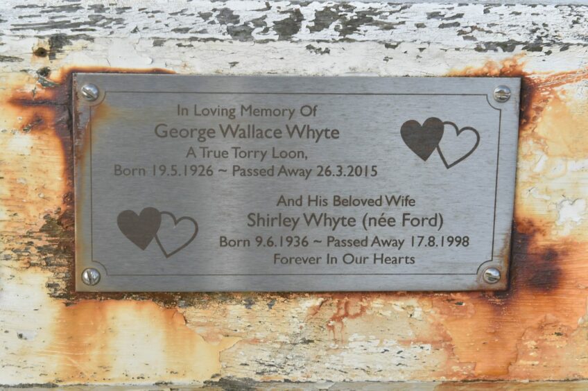 A plaque on the memorial bench. 